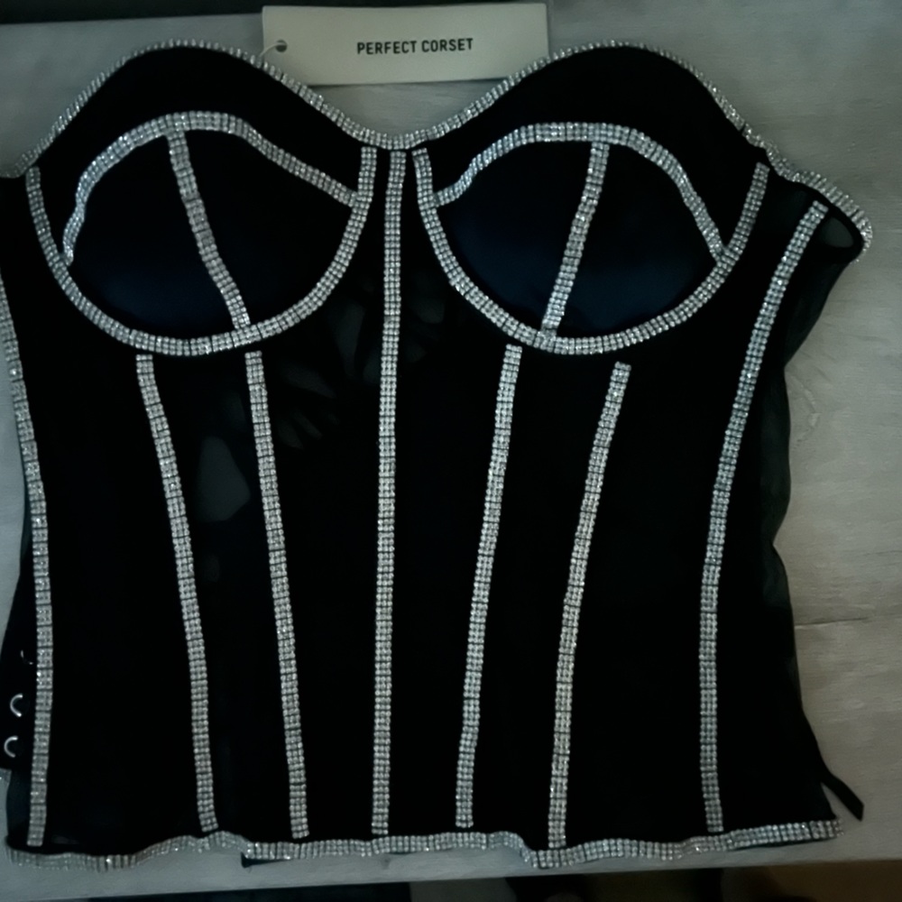 Lace up black corset with rhinestone lined binding